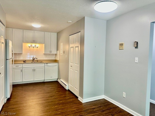 4376 Darrow Road, Unit 2 Stow, OH 44224 - Photo 12 of 26 Kitchen featuring white appliances, baseboard heating, a sink, dark wood-type flooring, and white cabinetry