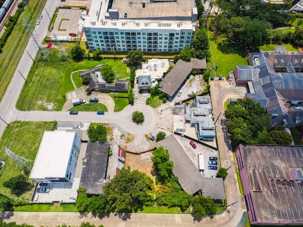 an aerial view of multiple houses with yard