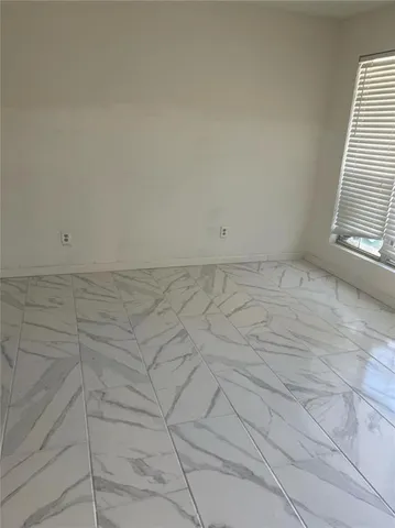 a view of staircase with white walls and a window