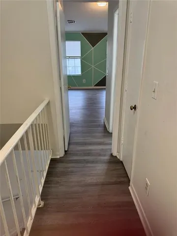 a room that has a rug and white checkered floor