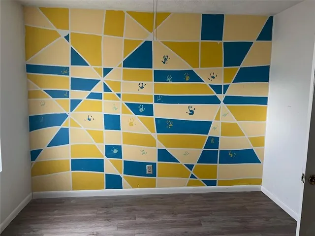 a view of a room with wooden floor