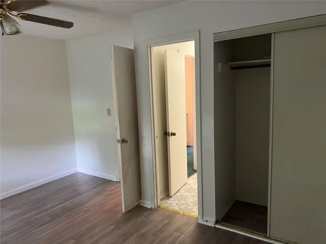 an empty room with wooden floor and entrance