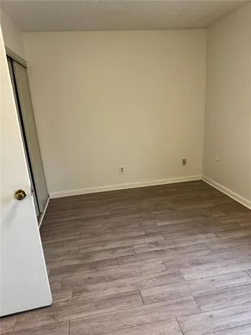 a view of room with wooden floor