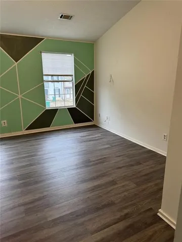 a view of a closet with wooden floor