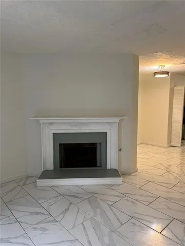 a view of an empty room and wooden floor