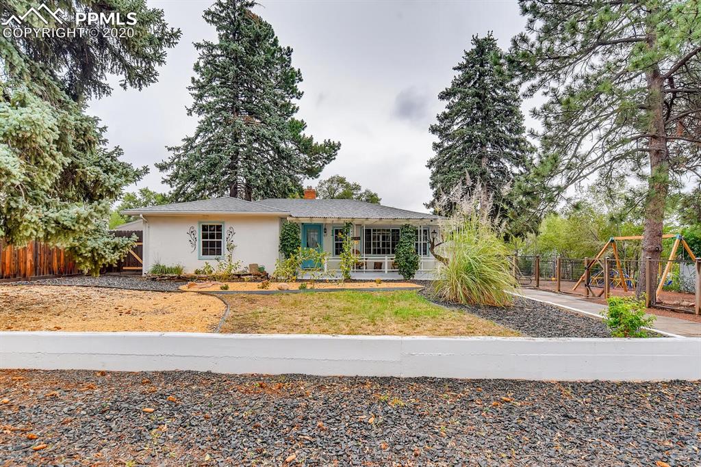 917 Prairie Road Colorado Springs, CO 80909 - Photo 3 of 27 Beautifully maintained yard with mature flora