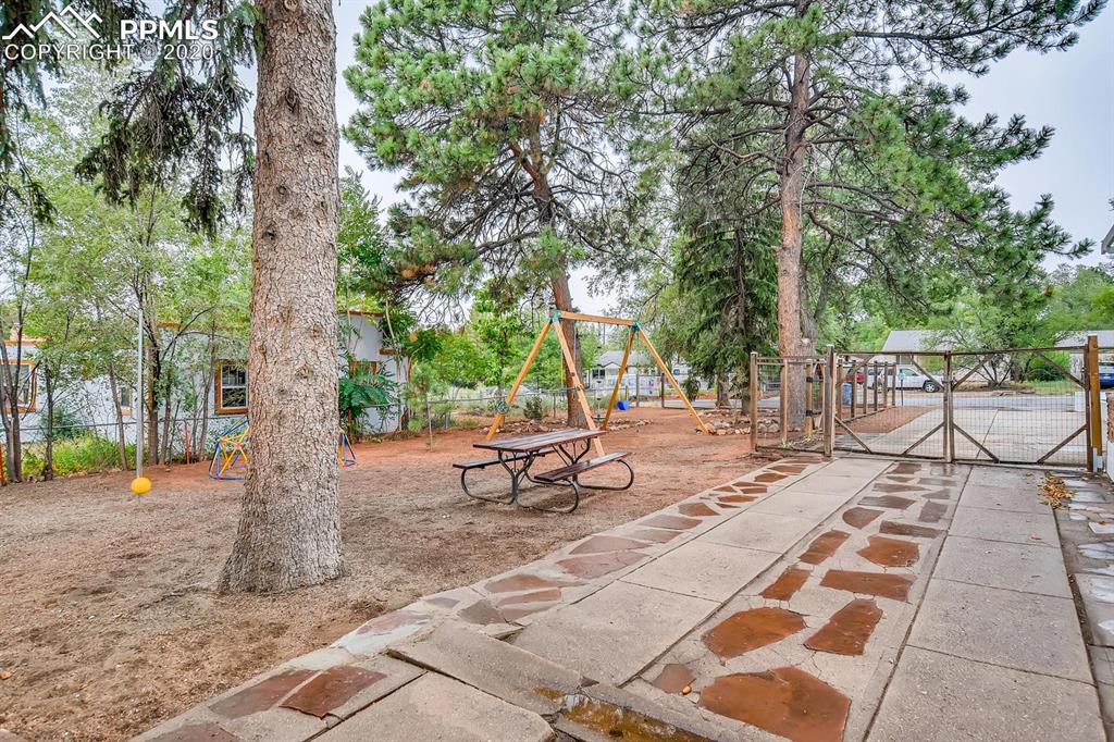 917 Prairie Road Colorado Springs, CO 80909 - Photo 21 of 27 Driveway & playground area