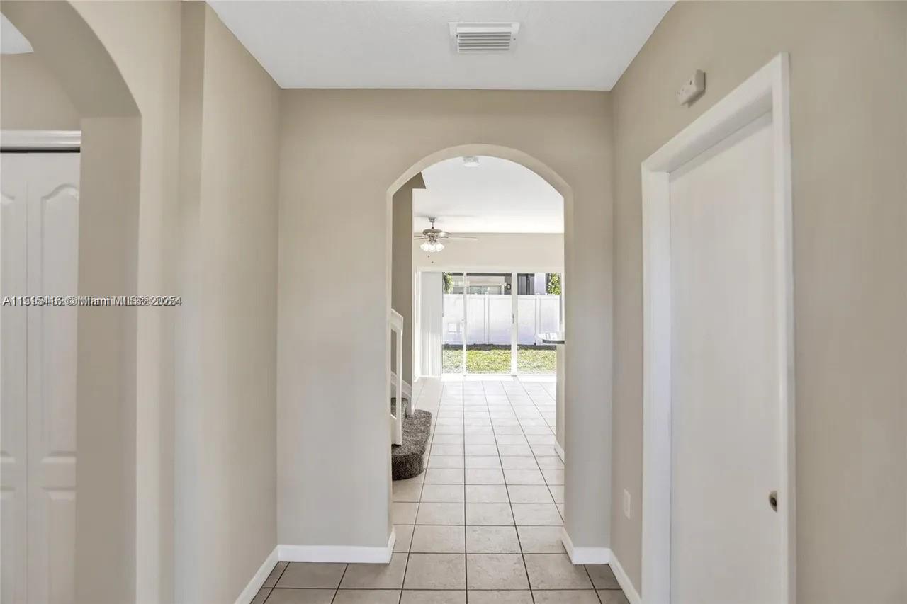 2802 Southwest 128th Way Miramar, FL 33027 - Photo 11 of 37 a view of a livingroom with wooden floor and a kitchen space