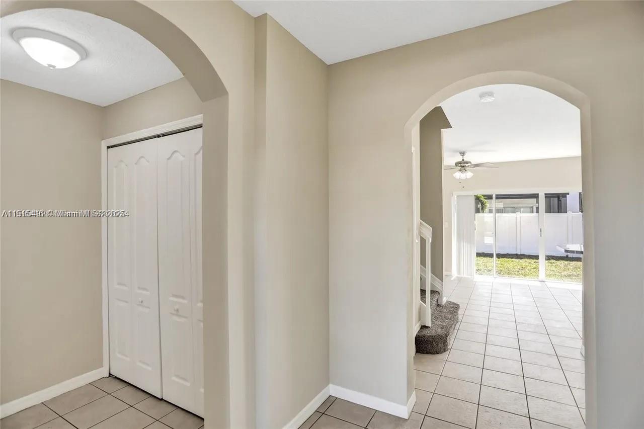 2802 Southwest 128th Way Miramar, FL 33027 - Photo 12 of 37 a view of a hallway with wooden floor and a bathroom