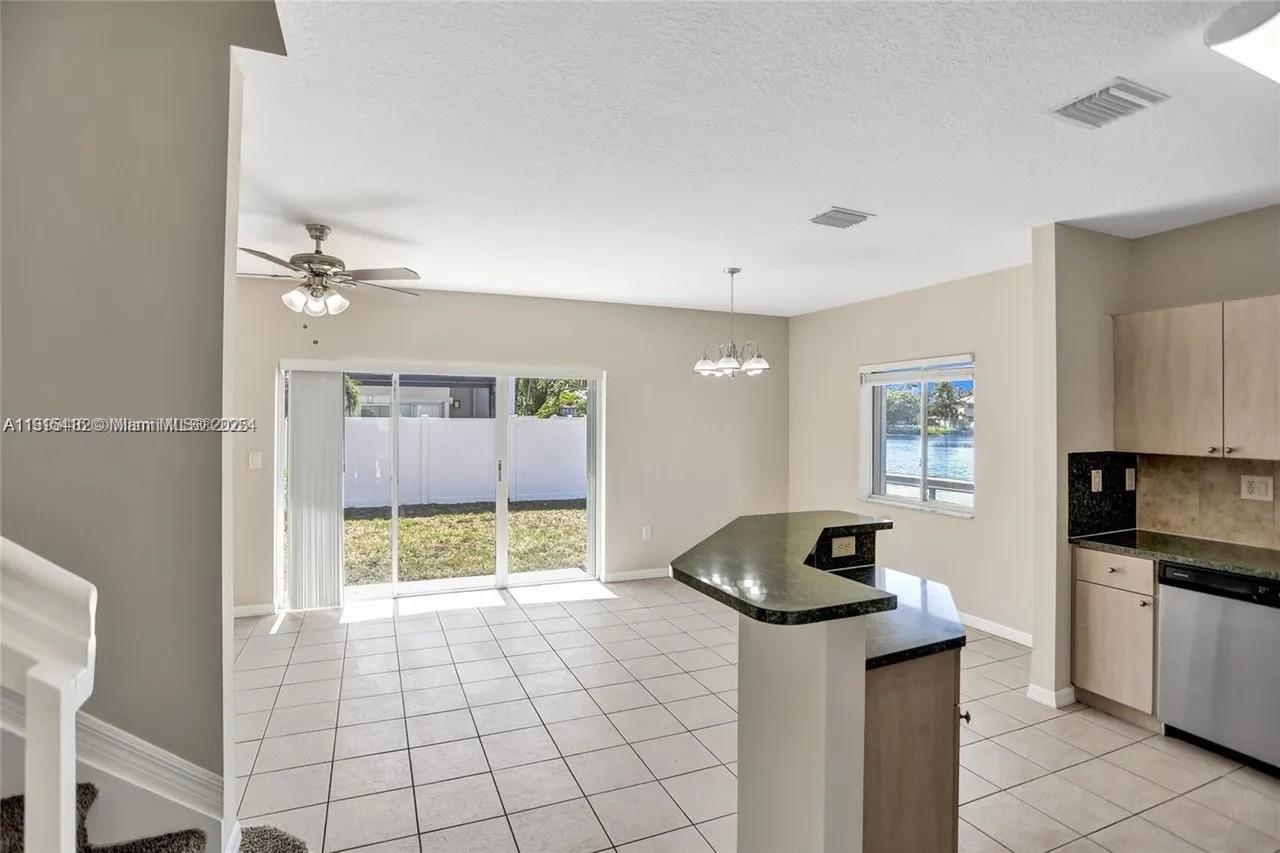 2802 Southwest 128th Way Miramar, FL 33027 - Photo 13 of 37 a living room with granite countertop furniture and a fireplace