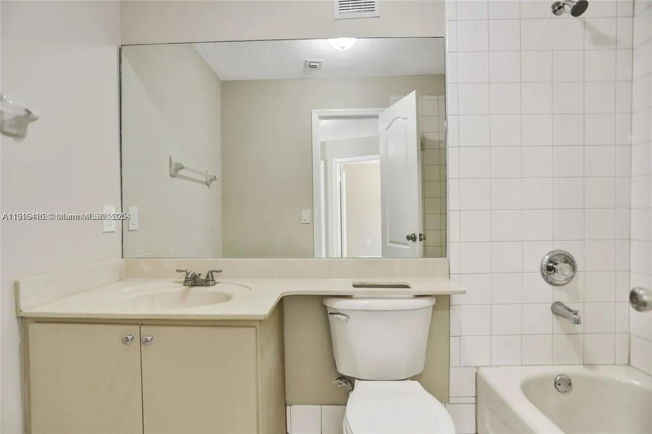 2802 Southwest 128th Way Miramar, FL 33027 - Photo 21 of 37 a bathroom with a toilet sink shower and mirror