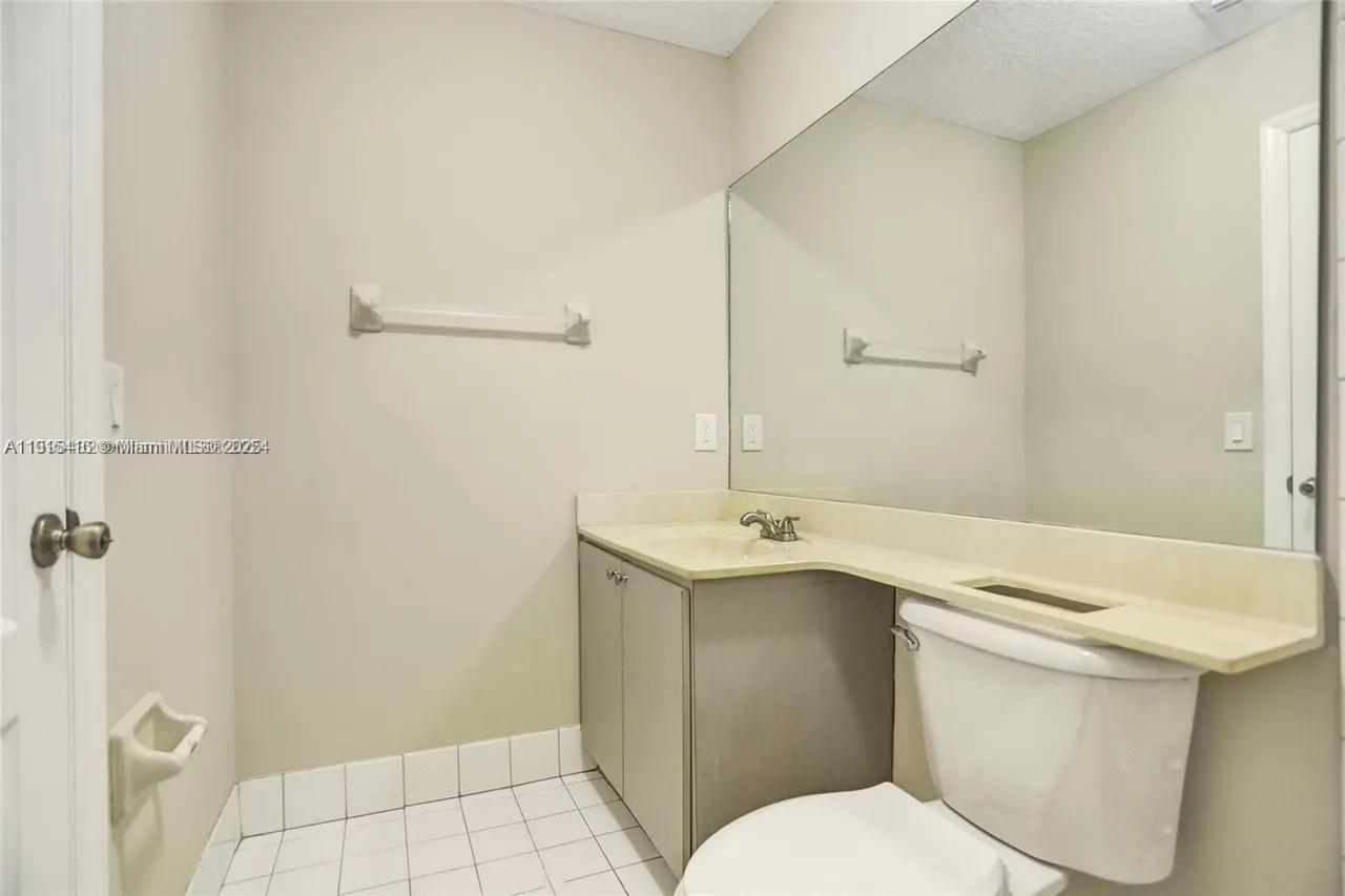 2802 Southwest 128th Way Miramar, FL 33027 - Photo 22 of 37 a bathroom with a granite countertop sink toilet and shower