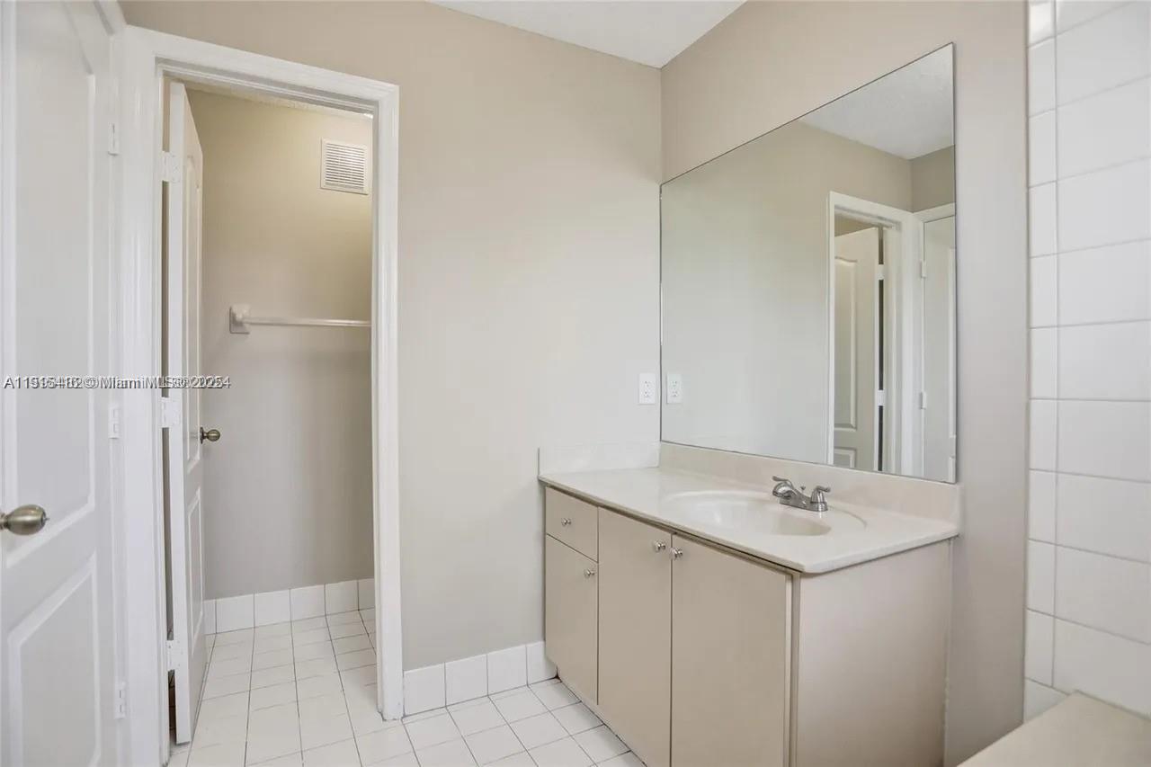 2802 Southwest 128th Way Miramar, FL 33027 - Photo 32 of 37 a bathroom with a sink and mirror
