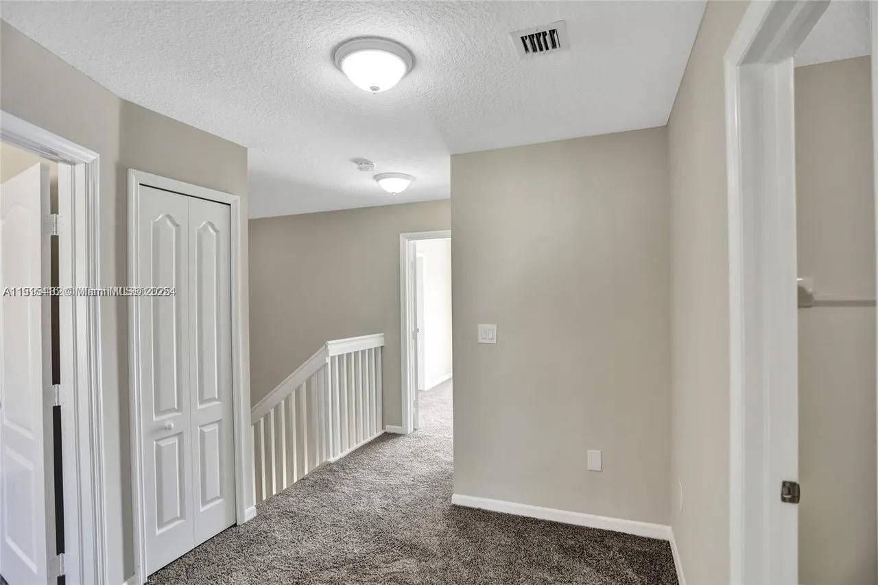 2802 Southwest 128th Way Miramar, FL 33027 - Photo 33 of 37 a view of a hallway with white walls
