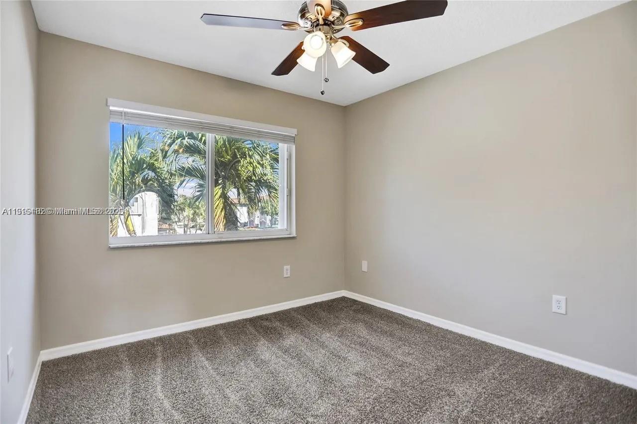 2802 Southwest 128th Way Miramar, FL 33027 - Photo 34 of 37 an empty room with a window and a fan