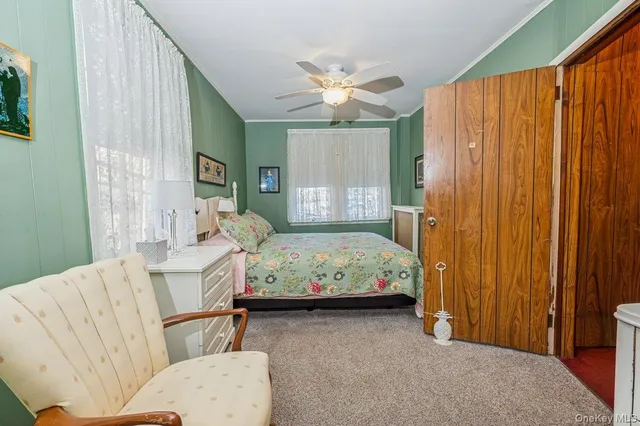 a bedroom with furniture and a large window