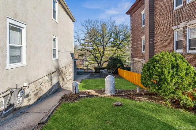 a view of a patio with table and chairs and potted plants