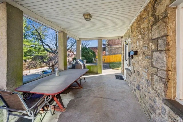 a view of a patio with a table and chairs