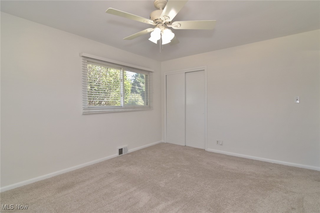 981 Hanley Road Cleveland, OH 44124 - Photo 19 of 42 Unfurnished bedroom featuring light colored carpet, a ceiling fan, and a closet