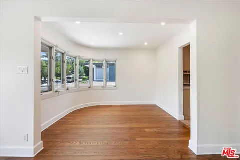 a view of kitchen and hall with wooden floor