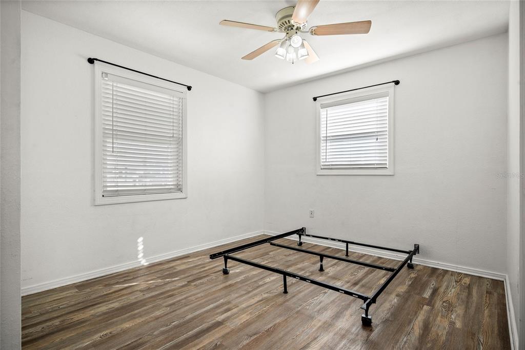 435 3rd Street Northwest Largo, FL 33770 - Photo 16 of 35 a room with chandelier fan and wooden floor