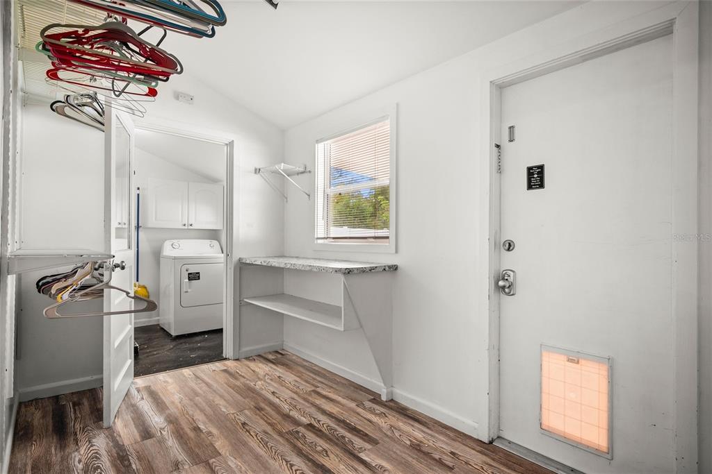 435 3rd Street Northwest Largo, FL 33770 - Photo 21 of 35 a bedroom with a bed and a chandelier