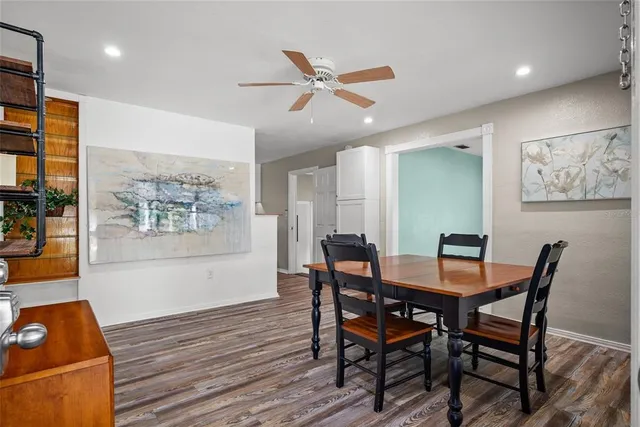 a view of a dining room with furniture and wooden floor