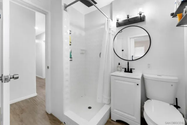 a bathroom with a toilet a sink and a mirror