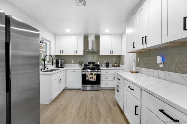 a kitchen with granite countertop a sink stove and cabinets