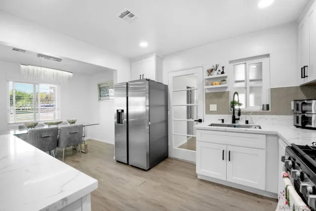 a kitchen with stainless steel appliances a sink stove and refrigerator