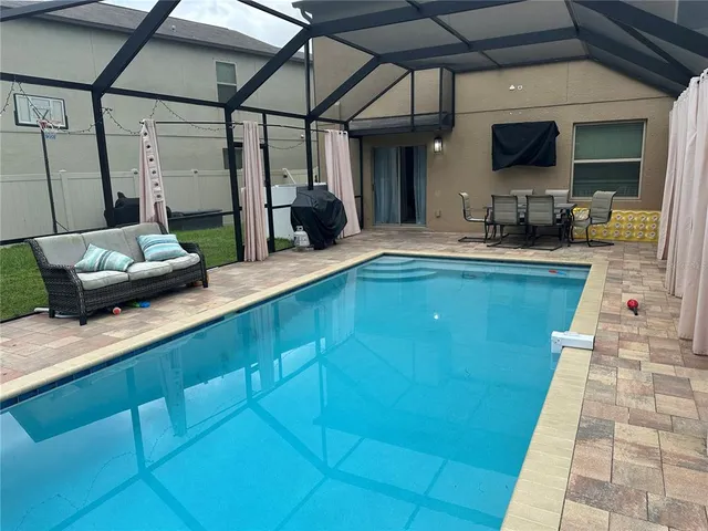 a view of a backyard with a wooden fence