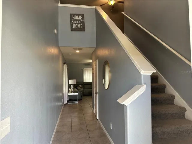 a view of a hallway with furniture and stairs