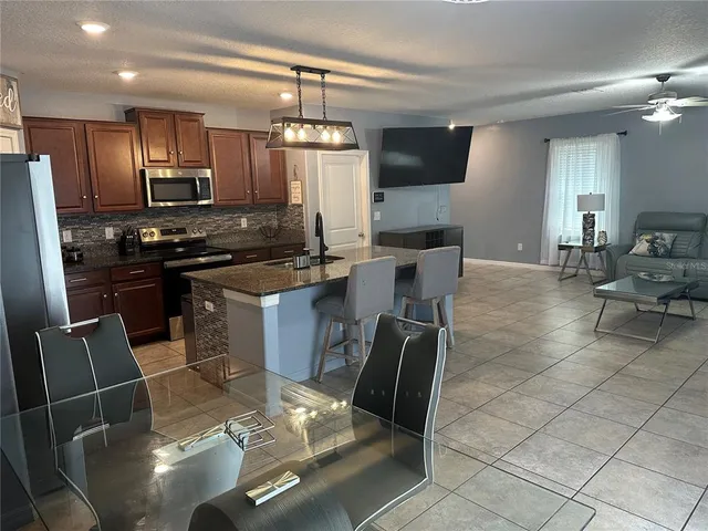 a kitchen with granite countertop a sink appliances and cabinets