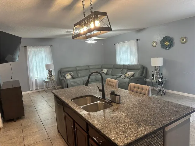 a kitchen with a sink a counter space and cabinets