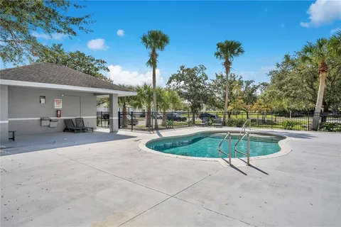 a swimming pool with outdoor seating and yard
