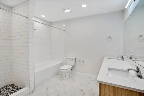 a bathroom with a sink toilet and shower