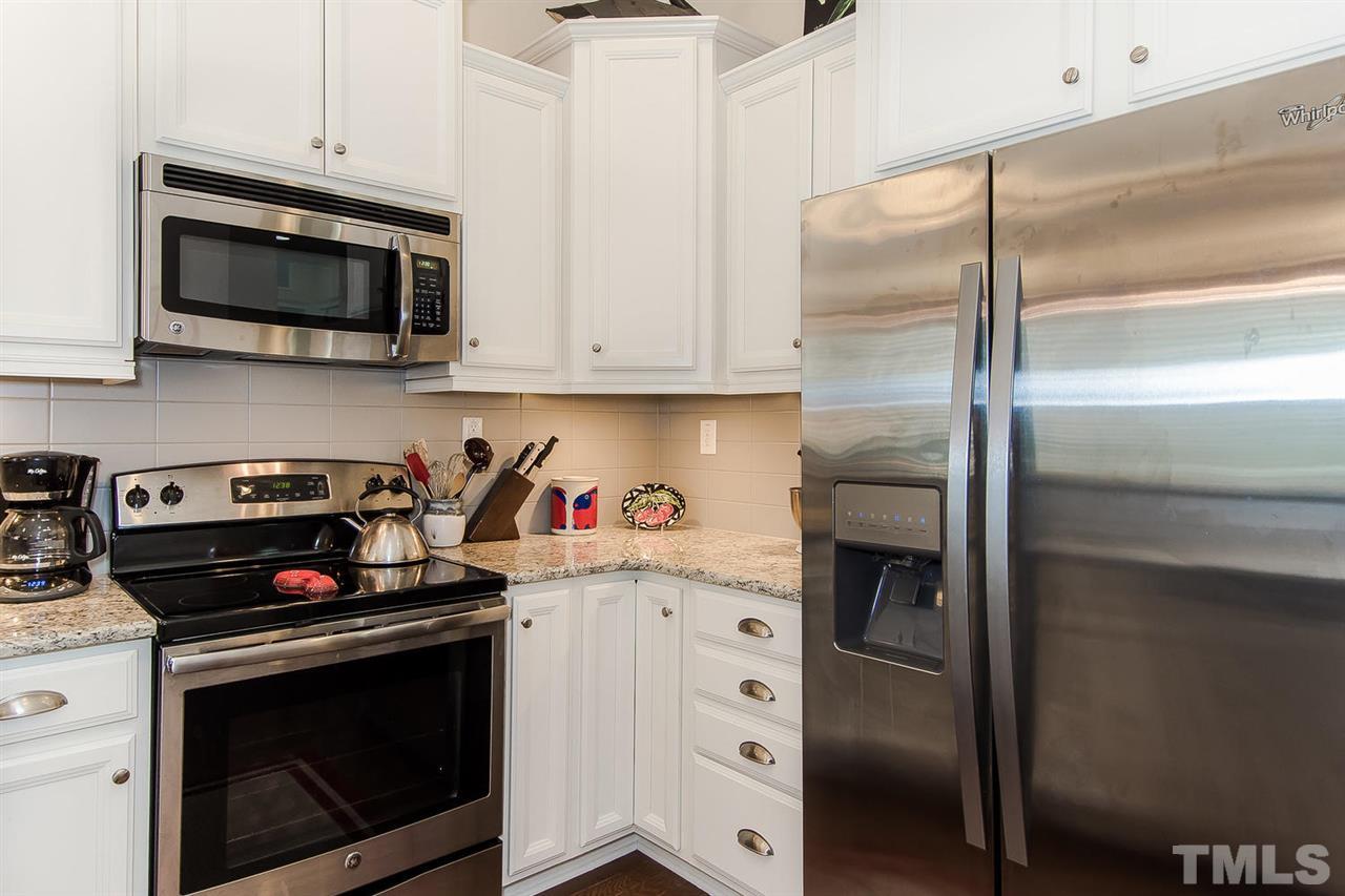 649 Fallon Grove Way Raleigh, NC 27608 - Photo 14 of 22 a kitchen with stainless steel appliances granite countertop a stove microwave and refrigerator