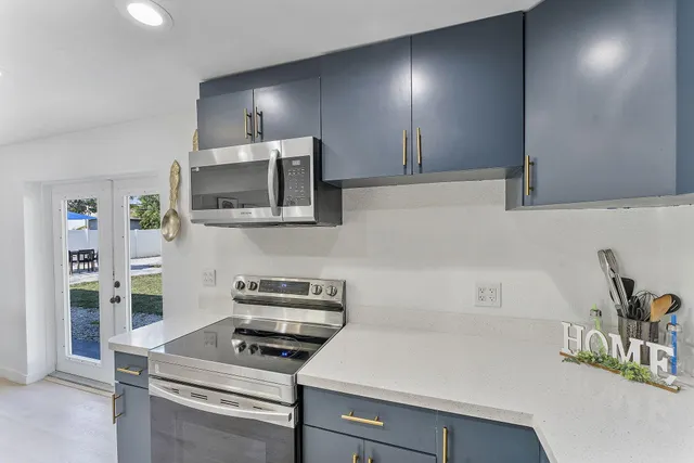 a kitchen with a sink and a stove top oven