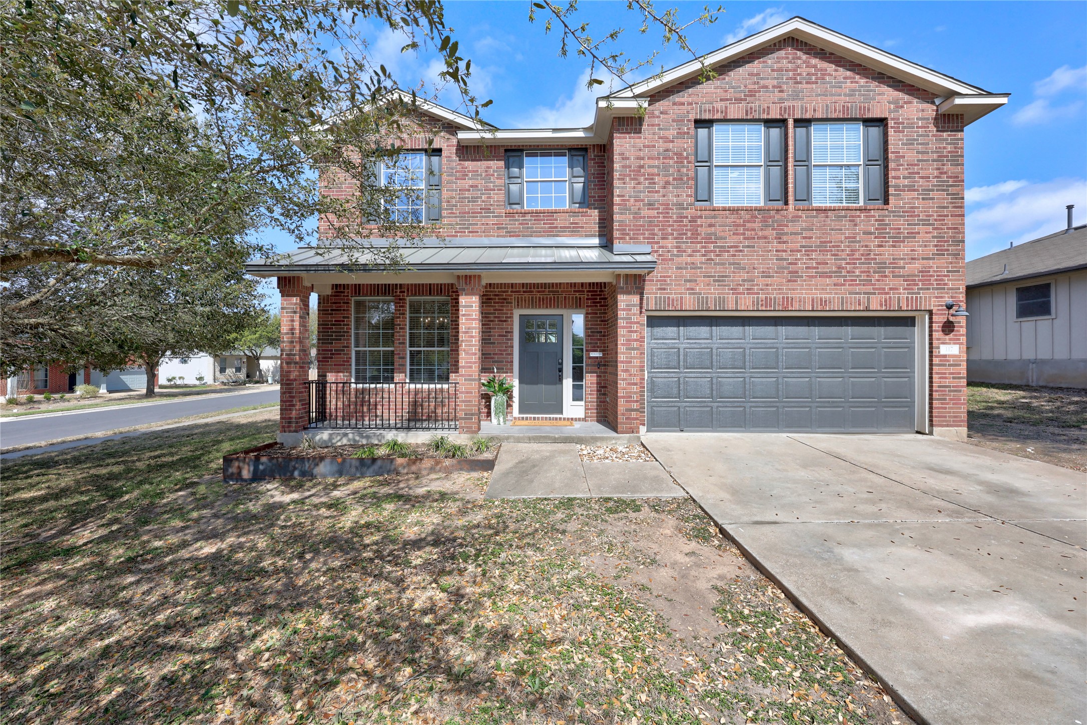 117 Waterloo Drive Kyle, TX 78640 - Photo 1 of 39 a front view of a house with a garden