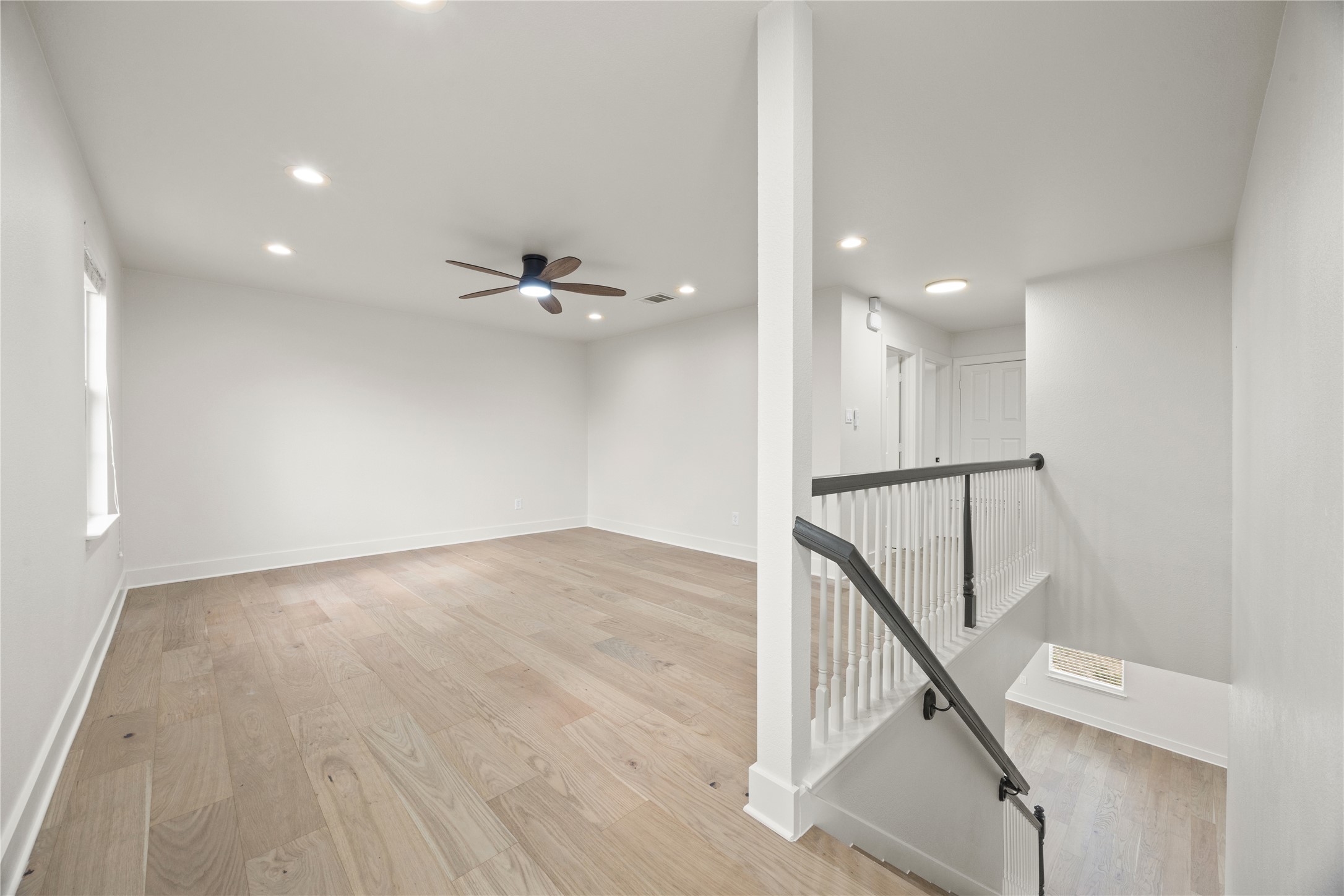 117 Waterloo Drive Kyle, TX 78640 - Photo 11 of 39 a view of an empty room with wooden floor and stairs