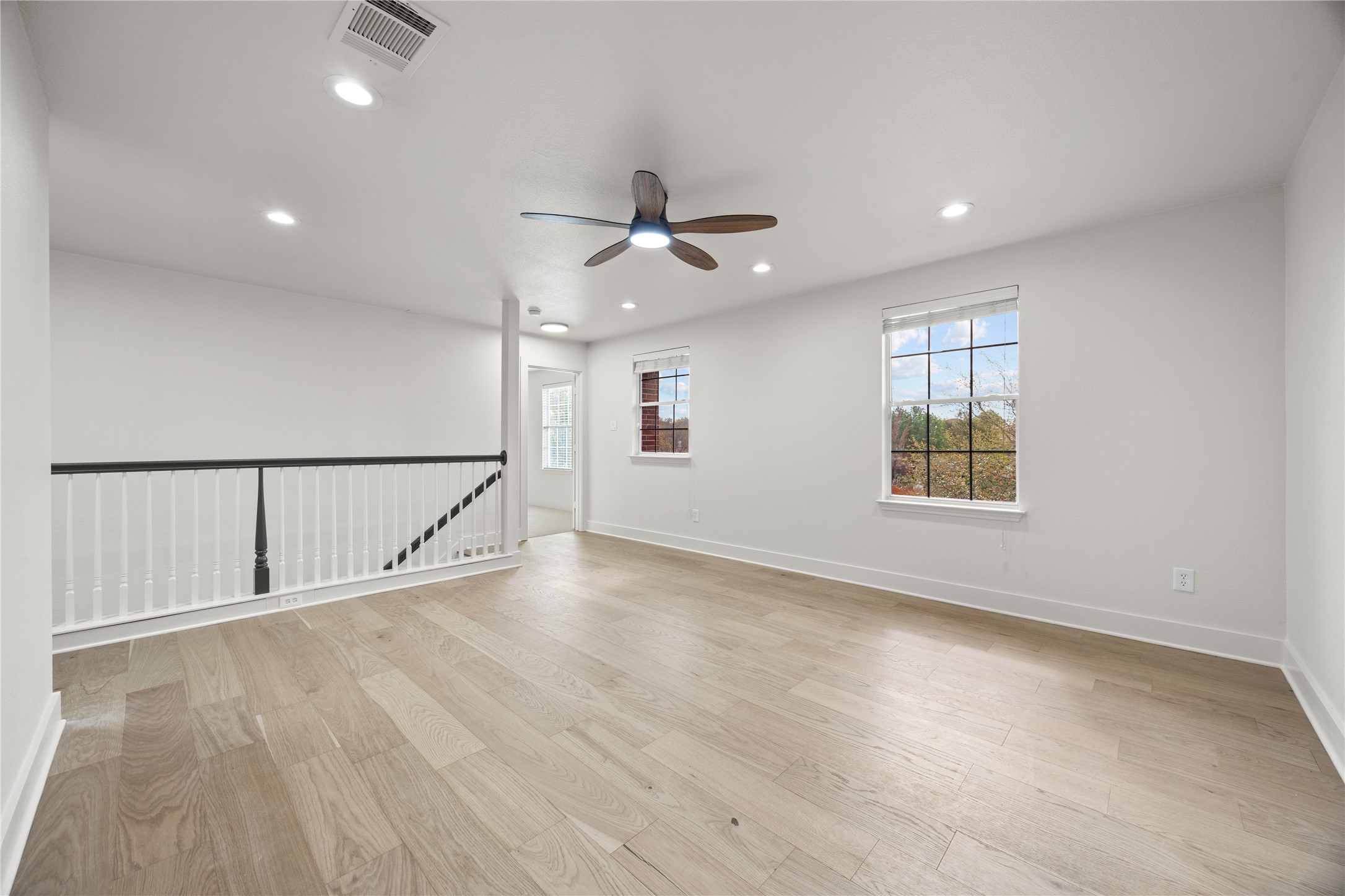 117 Waterloo Drive Kyle, TX 78640 - Photo 13 of 39 an empty room with ceiling fan and windows