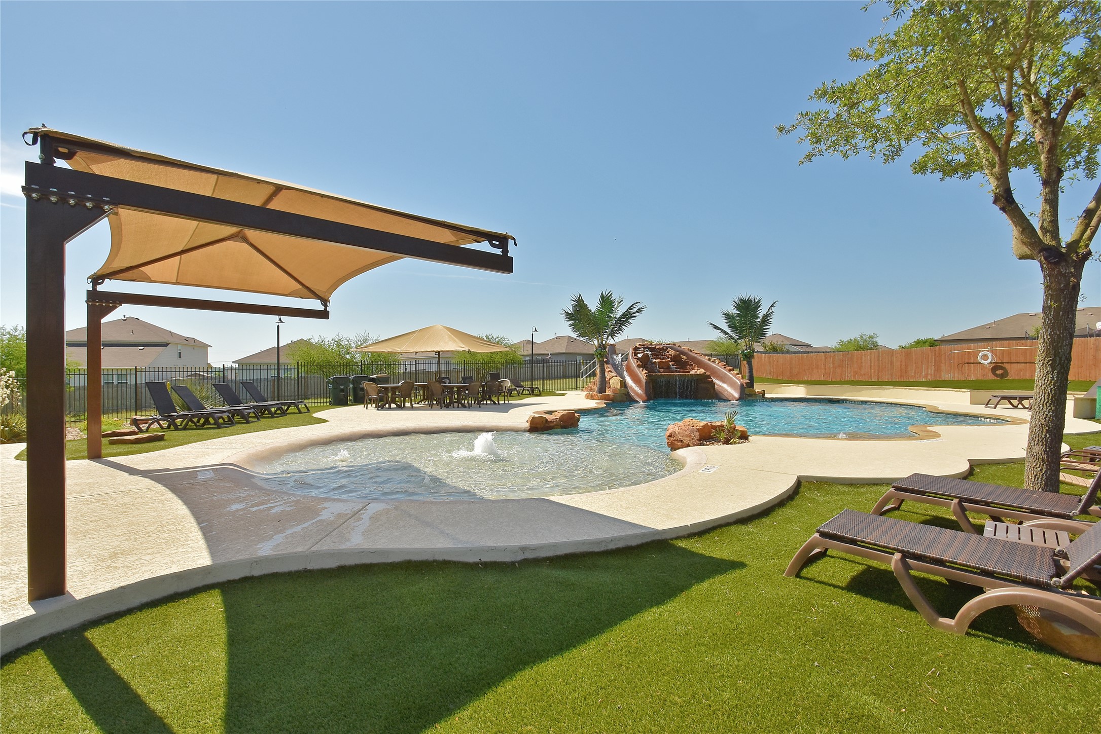 117 Waterloo Drive Kyle, TX 78640 - Photo 33 of 39 a view of swimming pool with outdoor seating and a garden