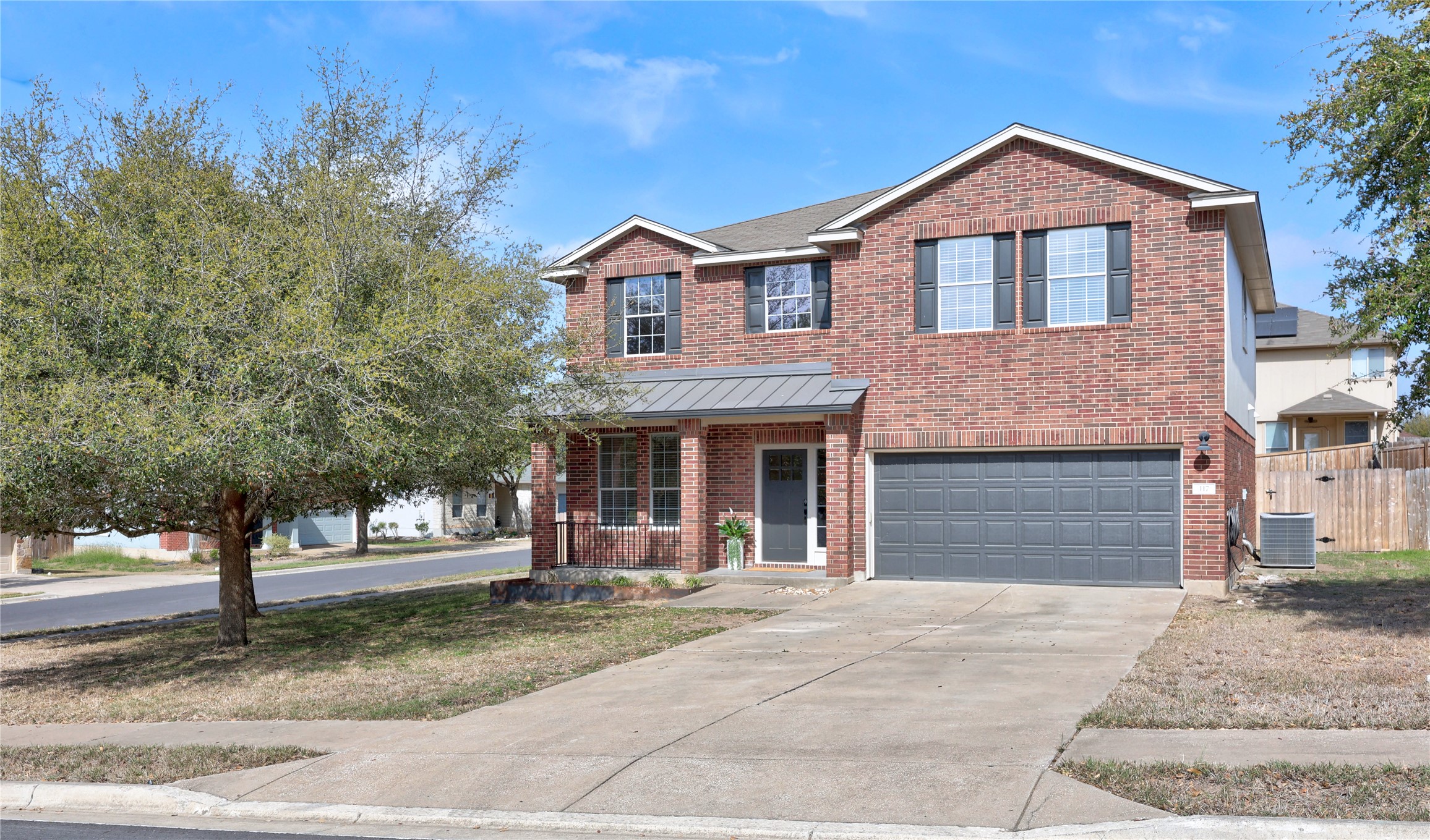 117 Waterloo Drive Kyle, TX 78640 - Photo 37 of 39 a front view of a house with a yard and garage