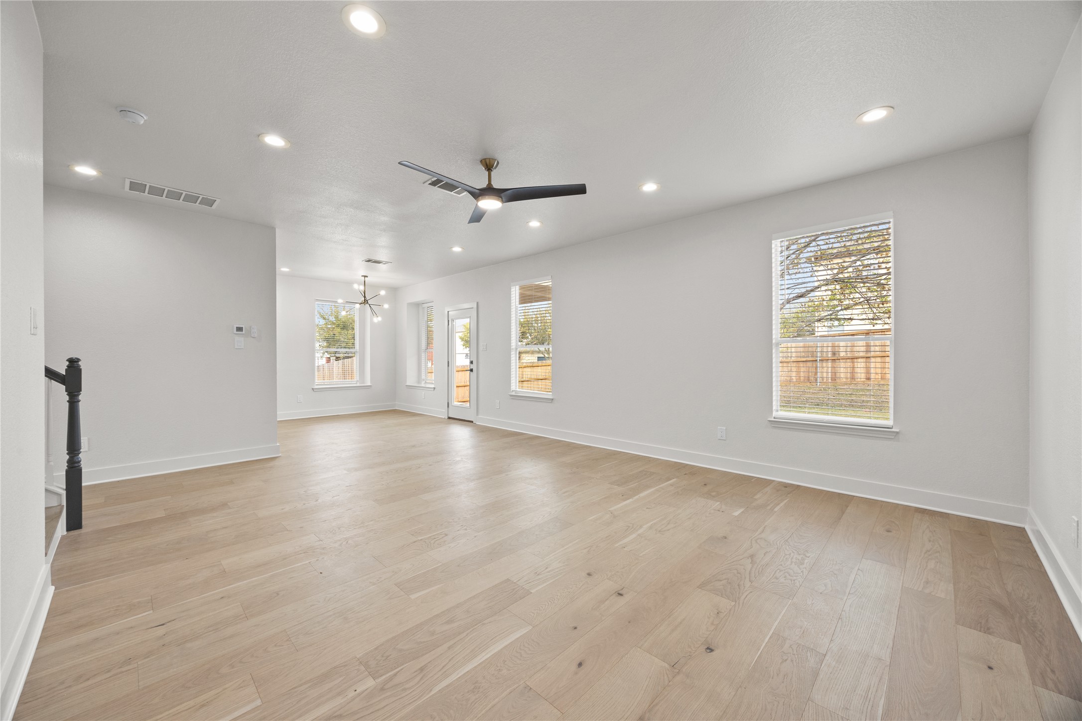 117 Waterloo Drive Kyle, TX 78640 - Photo 4 of 39 an empty room with wooden floor and windows