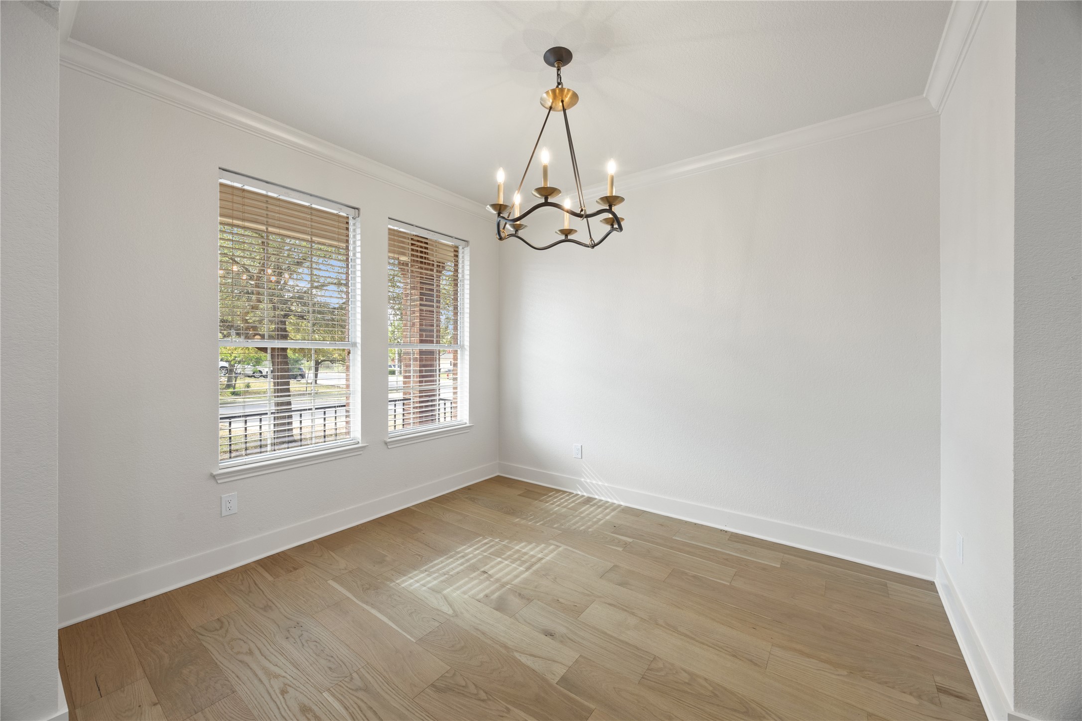 117 Waterloo Drive Kyle, TX 78640 - Photo 8 of 39 a view of an empty room with wooden floor and a window