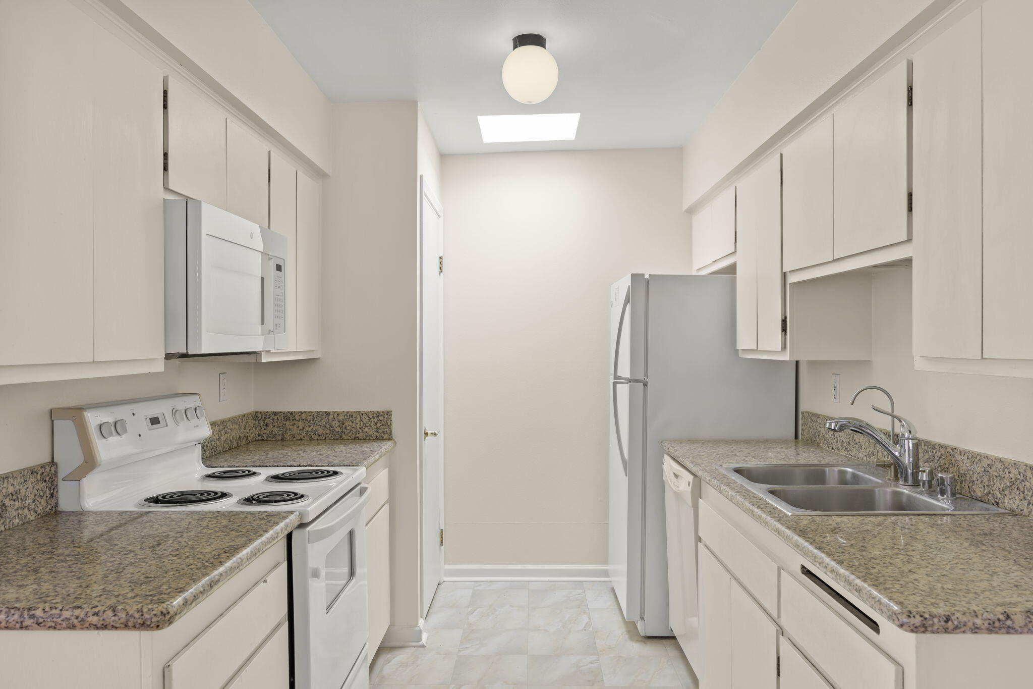 35 Dearborn Place, Unit 56 Goleta, CA 93117 - Photo 14 of 21 a kitchen with granite countertop a sink stove and refrigerator