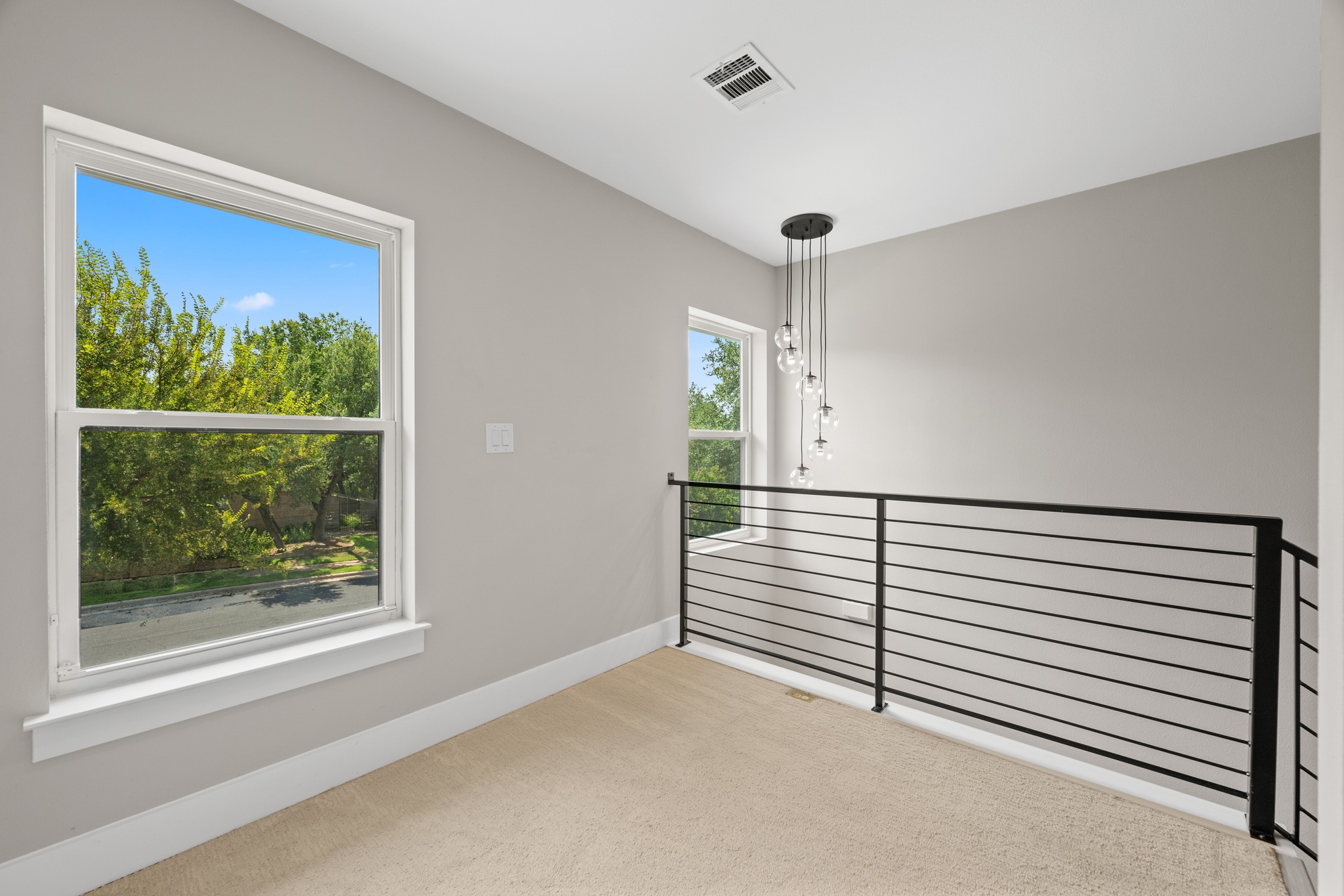11506 Autumn Ridge Drive Austin, TX 78759 - Photo 7 of 23 Upstairs landing with abundant natural light from multiple windows and contemporary railing overlooking the lower level.
