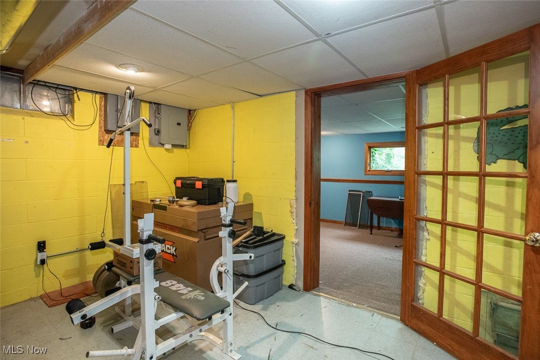 4962 Nettleton Road Medina, OH 44256 - Photo 36 of 43 Exercise area featuring electric panel, a paneled ceiling, and concrete block wall