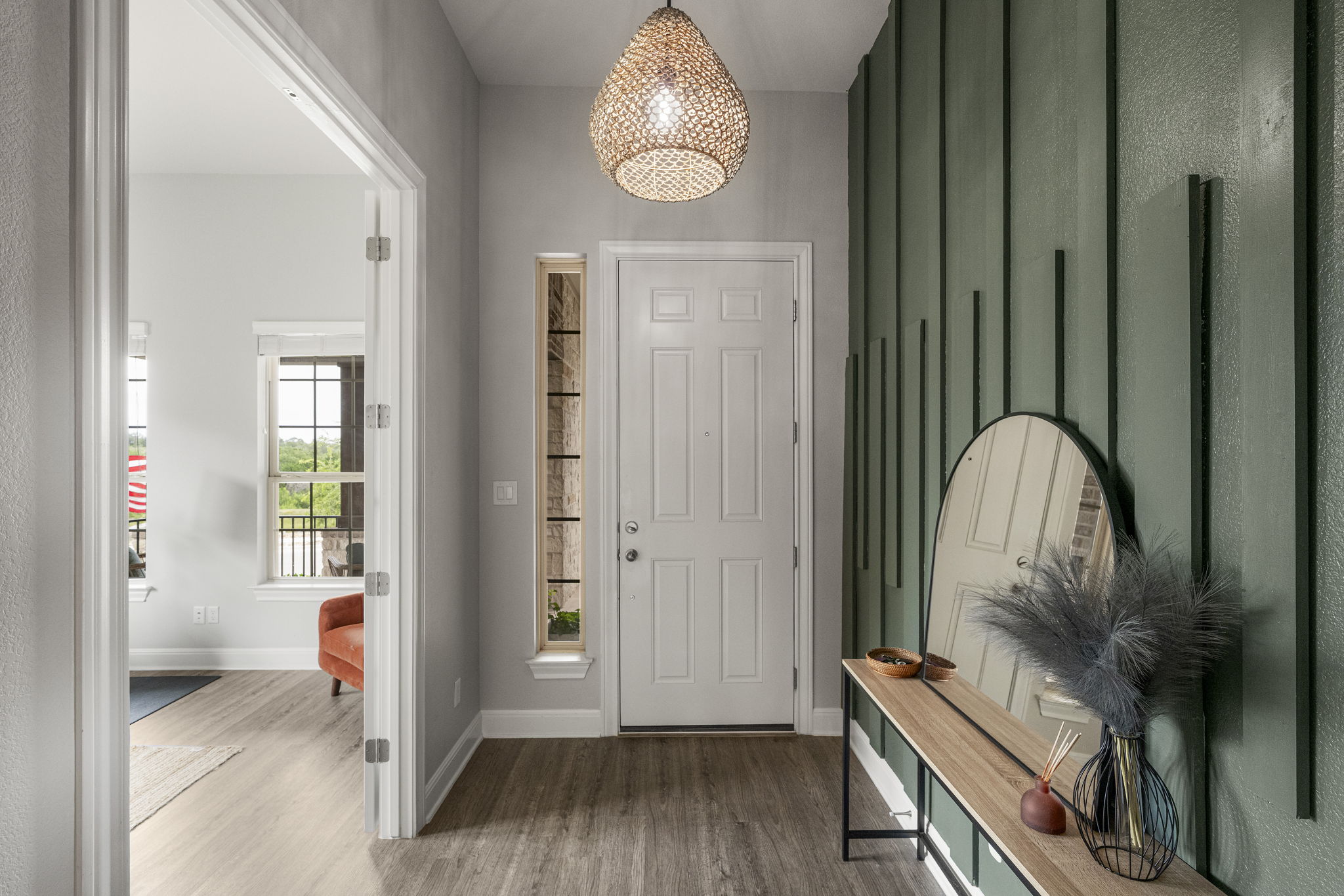 772 Founders Ridge Dripping Springs, TX 78620 - Photo 9 of 40 A true foyer entry creates a defined and welcoming introduction to the home with its designer lighting and panneled walls.
