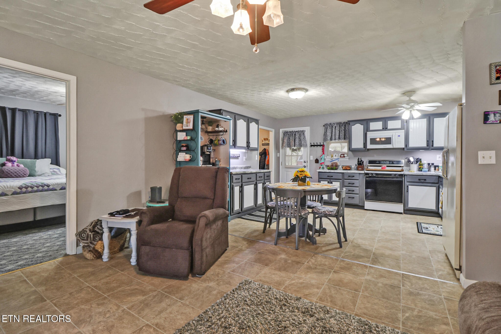 239 Doc Huling Road Robbins, TN 37852 - Photo 35 of 55 a living room with furniture and a dining table